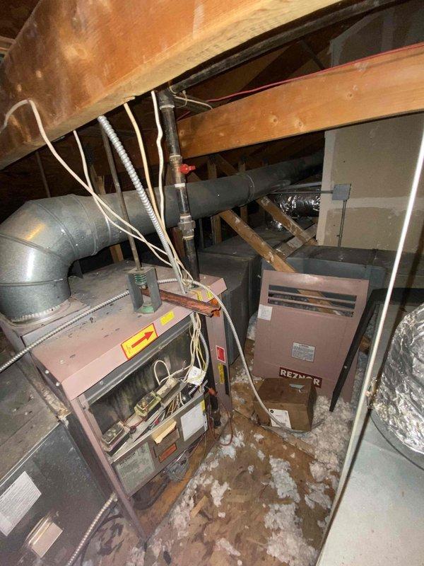 Conducted inspection of existing HVAC system in nursing home attic. Found significant deterioration of current equipment with rotting components. Measured ductwork connections (24") and examined Reznor unit with associated metal ductwork and connections. Recommended replacement with mini split system due to condition of existing equipment and space constraints.