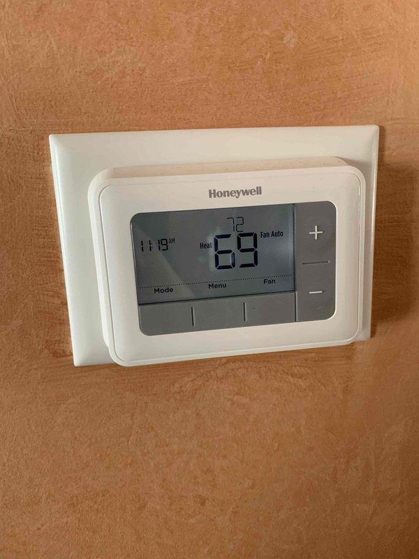 Responded to no-heat call for 20-year-old furnace system that had shut down. Upon arrival, found unit attempting to run fan with home temperature at 55°F. Diagnosed issue and restored heating function after system had been non-operational for approximately 9 hours. Thermostat now functioning properly with heat set to 72°F and actual temperature reading 69°F.