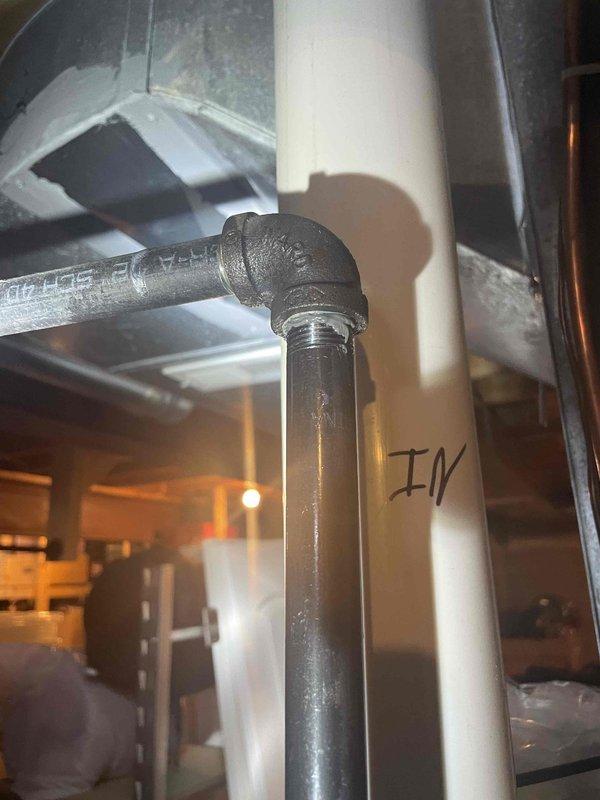 Responded to customer report of gas odor near recently installed furnace system. Inspected threaded gas pipe connections at the 90-degree elbow joint and identified minor gas leak at the fitting. Tightened the threaded connection and applied appropriate pipe sealant to ensure proper seal, then verified complete elimination of gas leak with testing equipment.