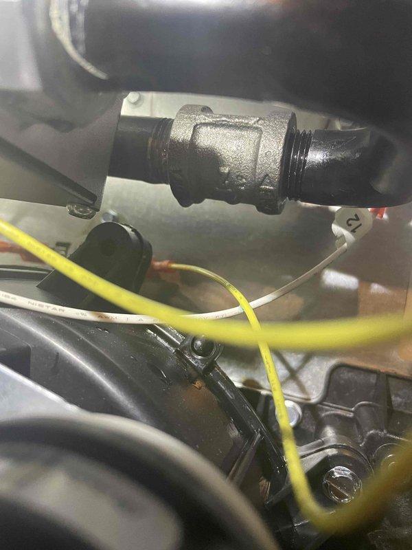 Responded to customer report of gas odor near recently installed furnace system. Inspected threaded gas pipe connections at the 90-degree elbow joint and identified minor gas leak at the fitting. Tightened the threaded connection and applied appropriate pipe sealant to ensure proper seal, then verified complete elimination of gas leak with testing equipment.