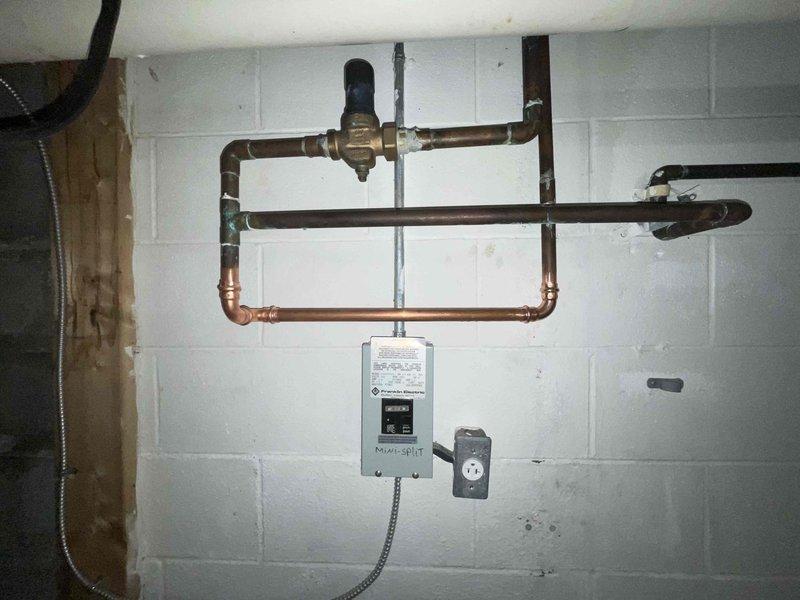 Responded to a water leak in basement. Located obsolete black filter on water pipe from previous well water system that was causing leakage. Since property now uses city water, removed unnecessary filter component and verified proper function of the main water supply system.
