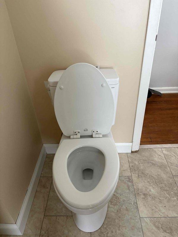 Returned to complete previously sold bathroom work after customer's new flooring installation. Installed toilet with new wax ring and set vanity using construction adhesive. Connected supply lines with new angle stops and completed p-trap installation for lavatory. All fixtures properly sealed with silicone where required and tested for proper operation.
