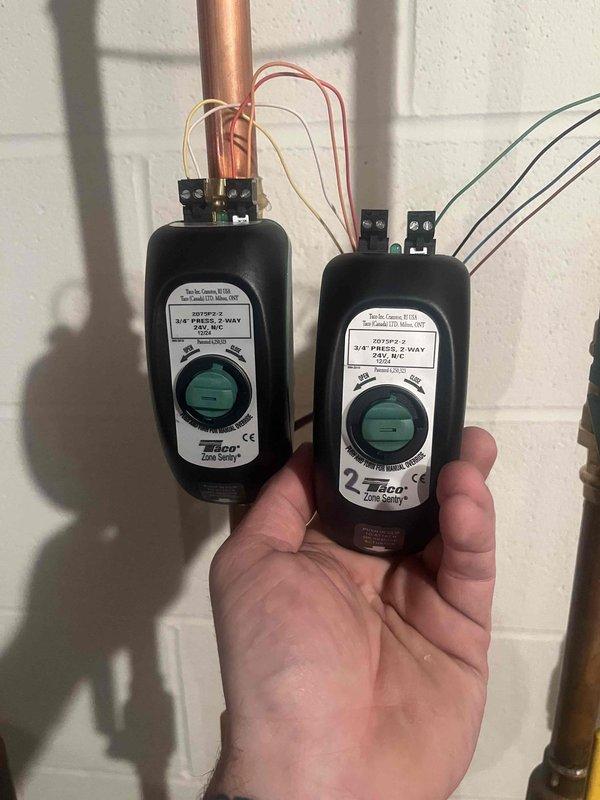 Diagnosed overheating issue in dining room where thermostat was reading 82°F despite being off. Inspected and replaced faulty Taco PBVF2 2-way zone valve controllers that were causing improper flow control. Verified proper operation of temperature sensors on supply lines and confirmed system now maintaining proper temperature control.