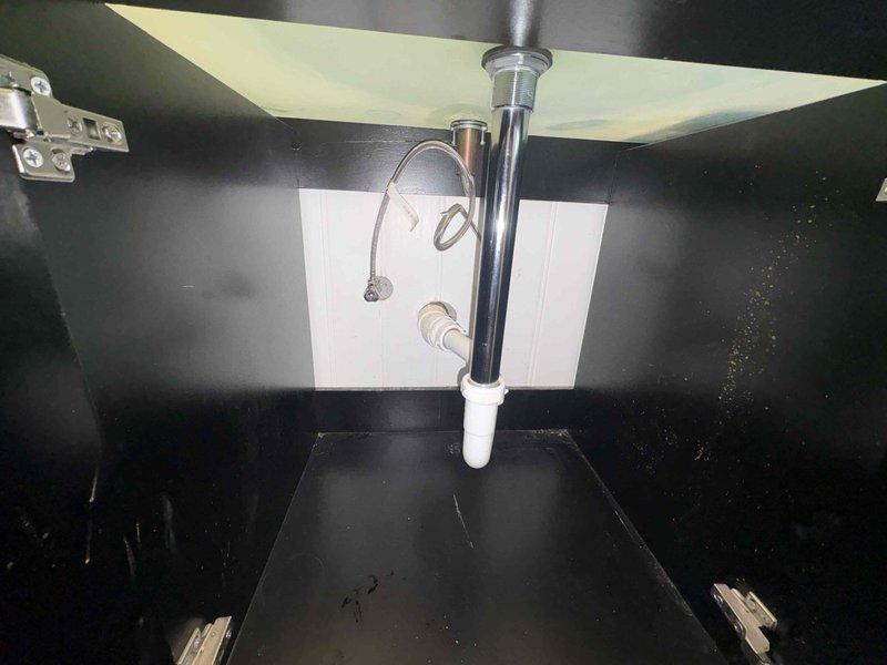 Responded to callback regarding slow draining sink following previous faucet replacement. Inspected under-sink plumbing components including P-trap and drain assembly. Cleared minor blockage in drain pipe that had accumulated after customer used sink contrary to previous technician's instructions. Verified proper drainage function before completing service.