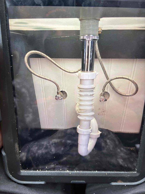 Responded to callback regarding slow draining sink following previous faucet replacement. Inspected under-sink plumbing components including P-trap and drain assembly. Cleared minor blockage in drain pipe that had accumulated after customer used sink contrary to previous technician's instructions. Verified proper drainage function before completing service.