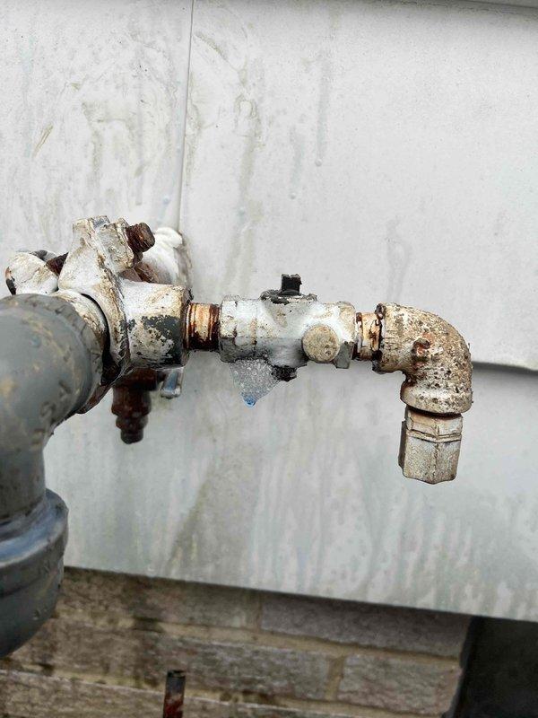 Responded to emergency call for gas leak inside residence. Performed thorough inspection which revealed corroded gas pipe fittings with visible leakage. Gas supply was shut off to ensure safety and prevent hazardous conditions. Completed pressure test to confirm leak source in piping located in wooden crawlspace area where rust staining indicated ongoing issue.