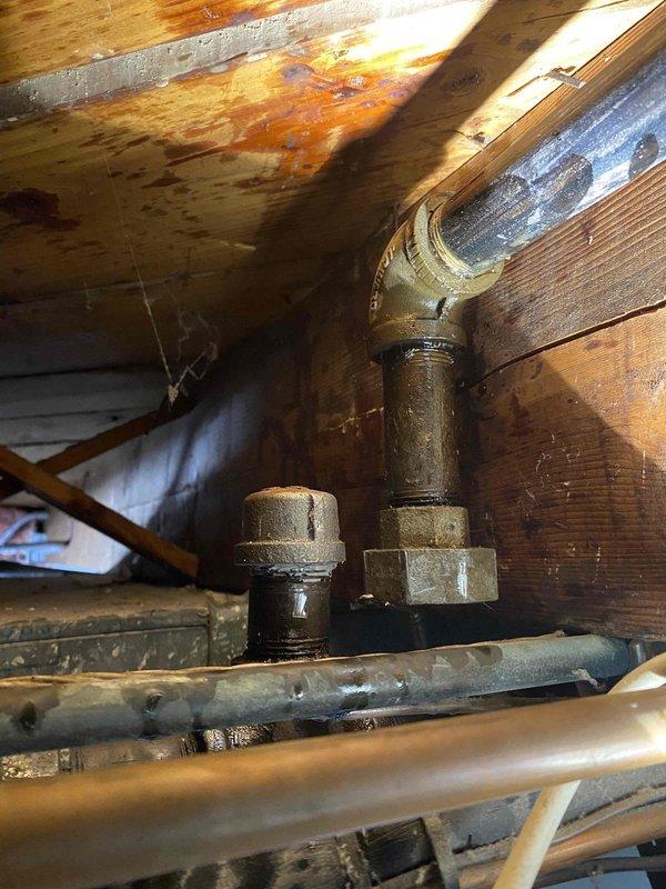 Responded to emergency call for gas leak inside residence. Performed thorough inspection which revealed corroded gas pipe fittings with visible leakage. Gas supply was shut off to ensure safety and prevent hazardous conditions. Completed pressure test to confirm leak source in piping located in wooden crawlspace area where rust staining indicated ongoing issue.