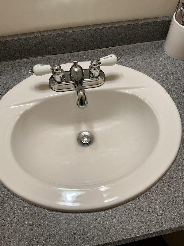 Performed routine plumbing maintenance visit to address dripping sink in downstairs bathroom. Inspected dual-handle chrome faucet with ceramic handles and examined copper supply lines with brass shut-off valves. Successfully repaired drip by adjusting valve components and verified proper operation before completing service.