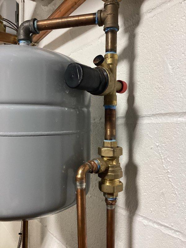 Performed scheduled KB-Boiler Only Maintenance Member Visit. Inspected boiler system components including expansion tank, copper piping, and brass valve assemblies - all found in proper working condition with no leaks or corrosion. Verified Honeywell Home ProSeries thermostat operation, confirming proper heat mode functionality with system maintaining set temperature of 66°F.
