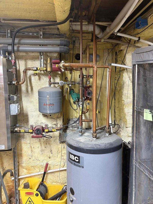 Responded to emergency service call for a failed radiator heating unit in manager's residence. Upon inspection, discovered significant water damage to surrounding flooring. Recommended complete replacement of the existing IBC boiler system. Performed assessment of current copper piping network and expansion tank to determine compatibility with new installation.