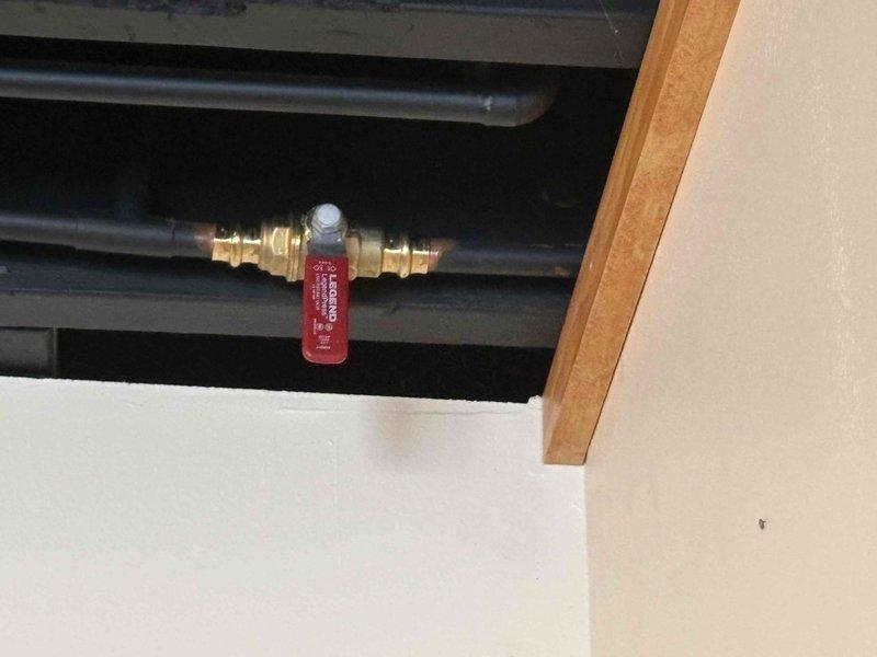 Responded to emergency service call for a leaking hose spigot causing interior water intrusion. Upon inspection, found water penetrating through the wall from exterior spigot connection. Shut off water supply, replaced damaged spigot assembly and sealed penetration point. Verified proper operation with no leaks after repair.