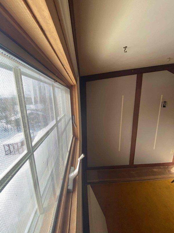 Conducted site assessment for potential mini split installation in an upper-level room with sloped ceiling. Room features carpeted flooring, multiple windows, and limited wall space. Identified optimal location for indoor head unit on exterior wall near window. Customer is coordinating with plumbing service for additional requirements.