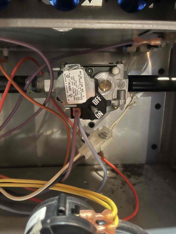 Diagnosed and serviced 2004 Goodman furnace with no heat complaint. Visual inspection revealed faulty gas valve with improper voltage readings. Heat exchanger inspection with thermal camera showed significant debris accumulation and heat exchanger temperature of 144°F, indicating compromised operation. Replaced gas valve, cleaned heat exchanger, and verified proper system operation before completing service.