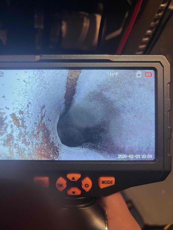 Diagnosed and serviced 2004 Goodman furnace with no heat complaint. Visual inspection revealed faulty gas valve with improper voltage readings. Heat exchanger inspection with thermal camera showed significant debris accumulation and heat exchanger temperature of 144°F, indicating compromised operation. Replaced gas valve, cleaned heat exchanger, and verified proper system operation before completing service.