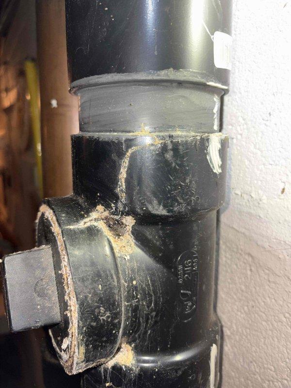 Responded to a kitchen drain clog service call. Upon inspection, discovered severely obstructed waste pipe with significant mineral and debris buildup that was restricting water flow. Removed and replaced damaged PVC drain sections showing deterioration at the joints. Customer's garbage disposal was non-functional and required replacement, which was installed and tested for proper operation.