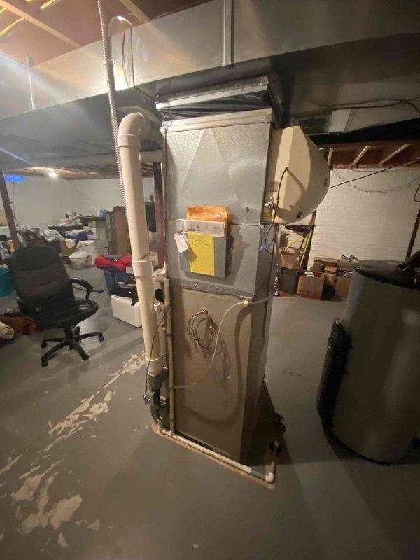 Performed diagnostic assessment on 2004 model furnace in client's basement which was confirmed non-operational. Inspection revealed end-of-life equipment with standard vertical configuration, connected to existing ductwork and PVC venting system. Client was presented with replacement options and documentation for consideration.