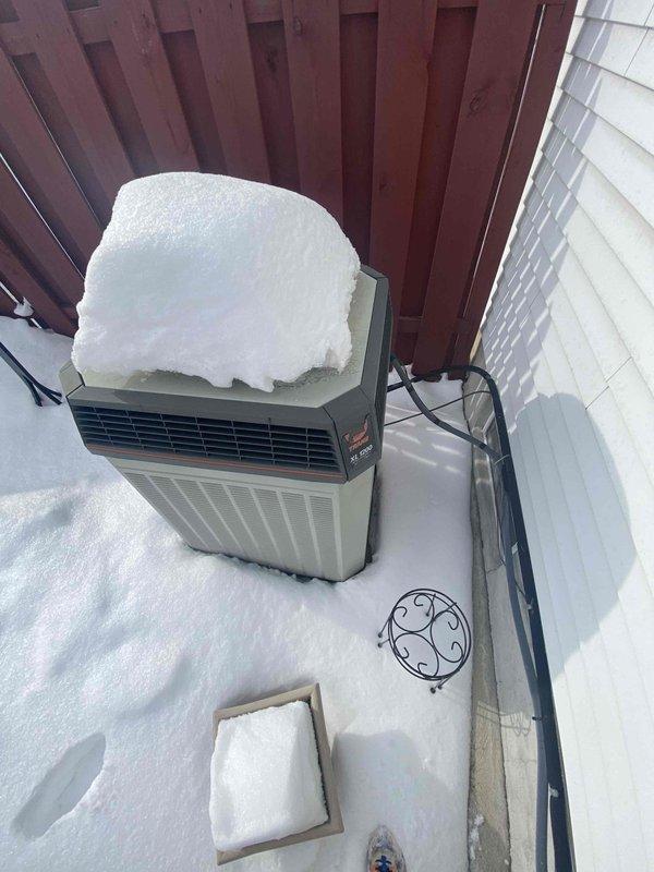 Performed comprehensive assessment of non-functional gas furnace system. Observed severely aged unit that customer reported failed several days prior. Exterior inspection revealed outdoor condensing unit completely snow-covered with potential maintenance issues. Interior inspection showed standard return air grille in functional condition. Based on system age and condition, replacement recommended over repairs.