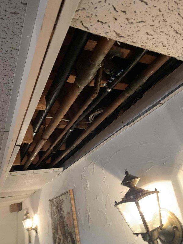 Responded to water leak issue from baseboard heating system. Upon inspection, accessed ceiling area to examine copper pipes and plumbing components. Located and repaired leak in baseboard heating pipe, preventing further water damage to surrounding area.