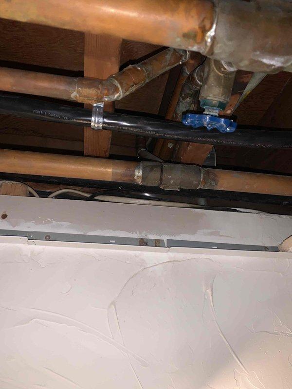 Responded to water leak issue from baseboard heating system. Upon inspection, accessed ceiling area to examine copper pipes and plumbing components. Located and repaired leak in baseboard heating pipe, preventing further water damage to surrounding area.