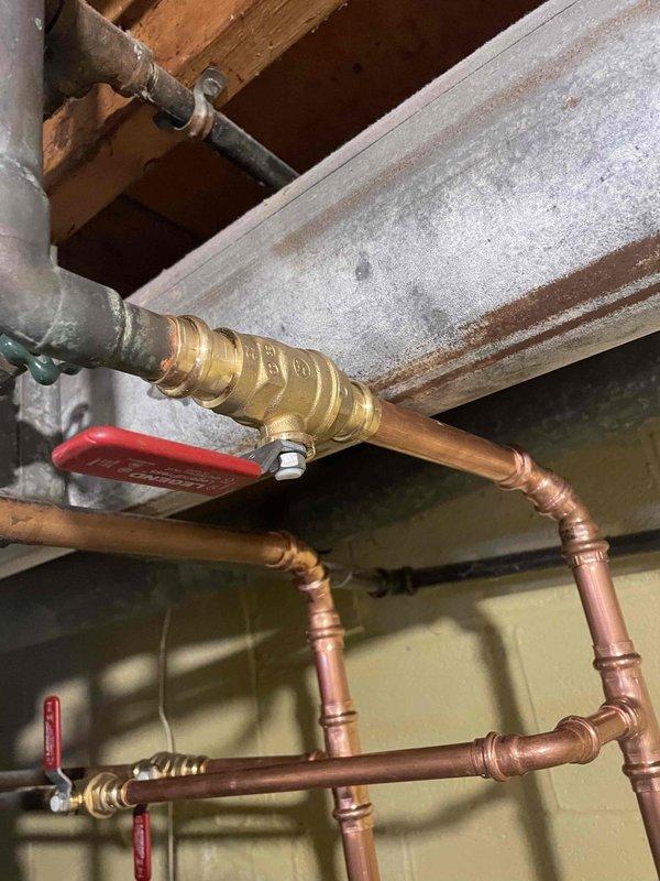 Successfully installed new 40-gallon low boy water heater, replacing previous unit that was heavily sedimented. Installation included new gas valve, two new 1/2" shutoffs, one new 3/4" shutoff, and new gas fittings from valve down. Water pan installed and existing flue reused for proper ventilation.