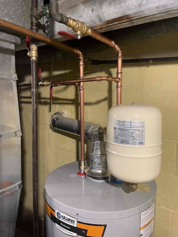 Successfully installed new 40-gallon low boy water heater, replacing previous unit that was heavily sedimented. Installation included new gas valve, two new 1/2" shutoffs, one new 3/4" shutoff, and new gas fittings from valve down. Water pan installed and existing flue reused for proper ventilation.