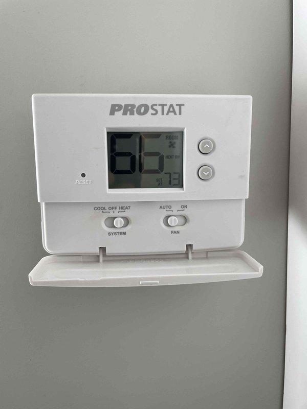 Responded to no heat complaint where customer reported indoor temperature at 66°F despite thermostat set to 73°F. Discovered clogged condensate drain in relatively new furnace system causing safety switch activation. Cleaned drain line components under running water to remove accumulated debris, restoring proper system operation and heat function.