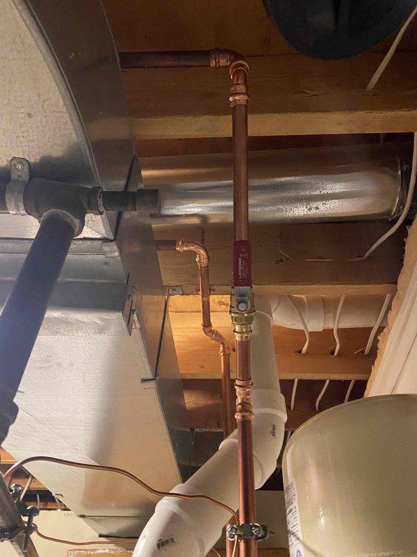 Completed installation of a 75-gallon power vented water heater with safety pans and thermal expansion tank (set at 75 PSI) as previously sold. System includes proper copper supply lines with brass shutoff valve, PVC venting, and drainage components, all professionally mounted and secured to structure.