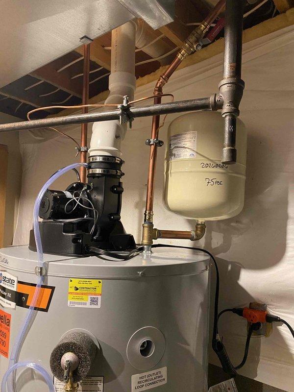 Completed installation of a 75-gallon power vented water heater with safety pans and thermal expansion tank (set at 75 PSI) as previously sold. System includes proper copper supply lines with brass shutoff valve, PVC venting, and drainage components, all professionally mounted and secured to structure.
