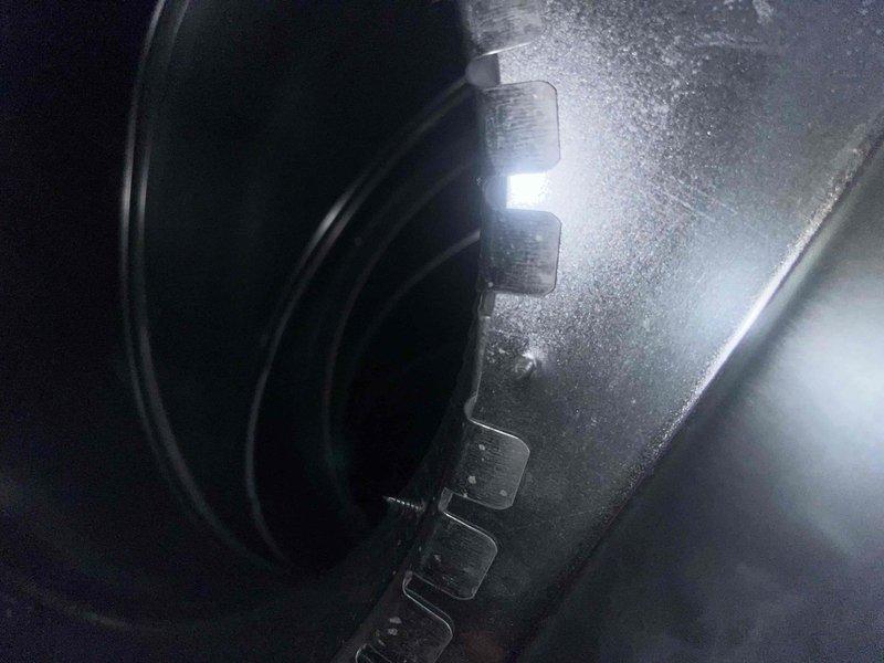 Inspected 1-year-old heat pump system responding to customer complaint of wet dog odor during defrost cycles. Conducted thorough examination of evaporator coils and condensate drainage system in attic-mounted air handler. Visual inspection confirmed clean coils with proper operation and verified condensate line had appropriate pitch for effective drainage, eliminating potential blockage concerns.