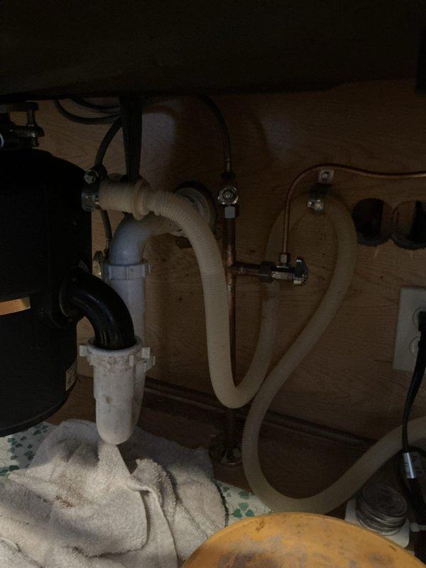 Responded to plumbing club member's issue with kitchen faucet exhibiting decreasing water pressure as temperature increases. Inspected under-sink plumbing components and supply lines, noting temporary resolution occurs when cycling shut-off valve. Diagnosed potential mineral buildup or pressure regulator issue in faucet assembly that will require follow-up service for permanent resolution.