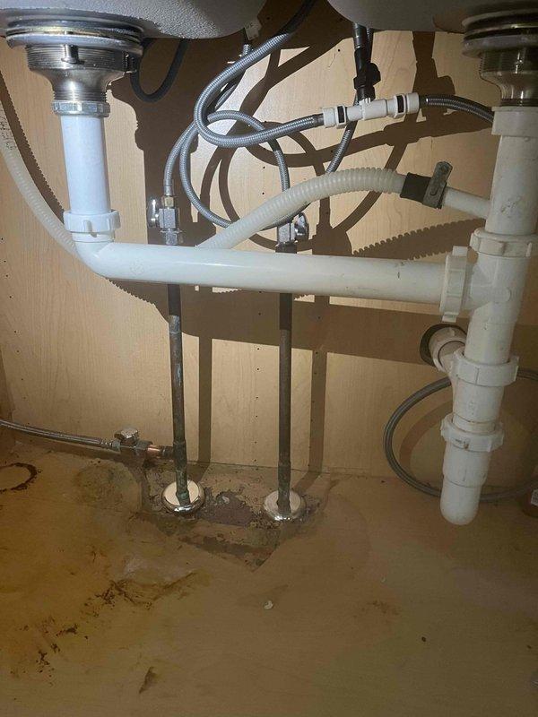 Responded to a water leak issue in upstairs bathroom affecting ceiling below. Diagnosed toilet leak and drainage problems causing water to back up in sink and toilet. Replaced damaged supply lines and drain pipes under fixtures, and installed new P-trap assembly to resolve gurgling and backflow issues. Advised customer to avoid using affected bathroom until repairs fully cure.