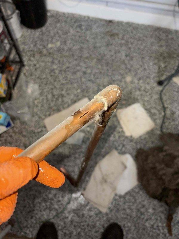 Identified and replaced corroded copper pipe joint showing significant mineral buildup and cracking that was causing a leak in the structural cavity. Documented damage to surrounding wood with visible water staining near the elbow connection. Consulted with Jason regarding the repair.