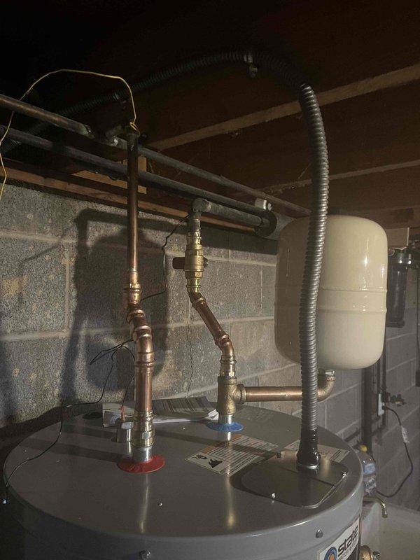 Performed inspection of existing water treatment system which was found to be on bypass. Noted that the equipment installed was not our brand. Documented current water heater installation including expansion tank and associated plumbing connections. Water heater appears to be properly installed with all necessary supply lines, pressure relief valves, and connections in place.
