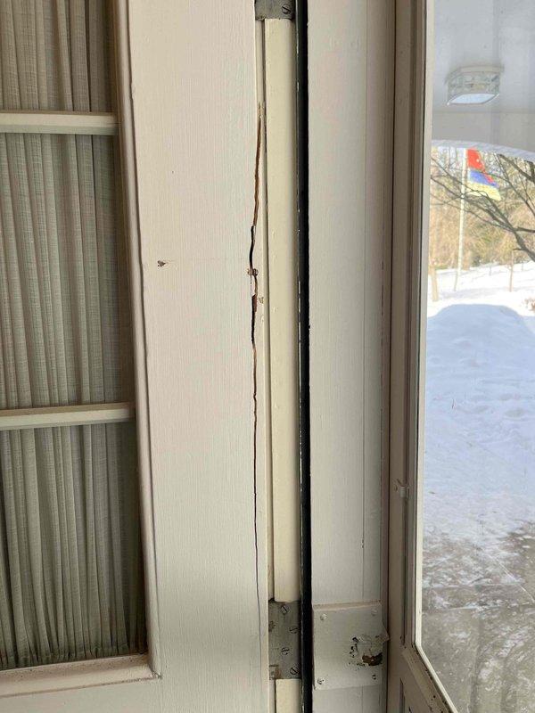 Responded to no hot water complaint. Inspected Lochinvar water heater system in utility room showing signs of moisture damage on surrounding concrete walls and floor. Noted unrelated damage to entry door frame with significant vertical cracking. Diagnosed and reset water heater, restoring hot water functionality.