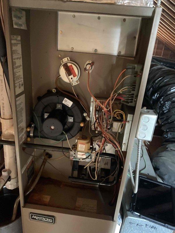 Responded to service call for Armstrong furnace not reaching set temperature (76°F set, 72°F actual). Inspected unit in attic installation, examined blower assembly, control board, and electrical components. System was operational with proper airflow but insufficient heating capacity. Diagnosed issue and completed necessary adjustments to restore proper temperature regulation.