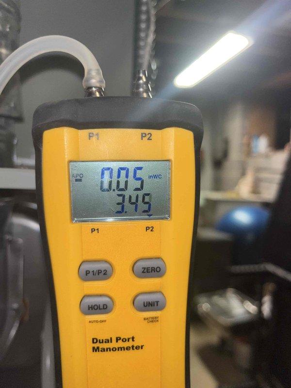 Completed club maintenance visit. Performed diagnostic measurements using dual port manometer (readings: 0.05 inWC, 345) and Fieldpiece SC440 clamp meter (0.10 amps, 0.7 volts AC). Documentation photos taken of testing equipment and readings.
