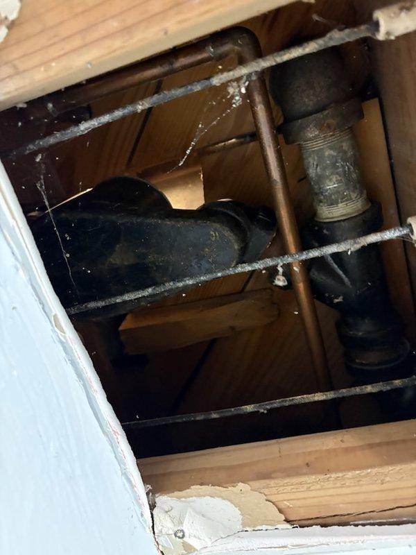 Completed return service for previously sold tub waste and overflow repair. Successfully removed aging cast iron drain piping and replaced with new PVC components, connecting to the existing PVC drainage system. Work required access through ceiling to reach and properly transition the old cast iron waste line to modern materials.