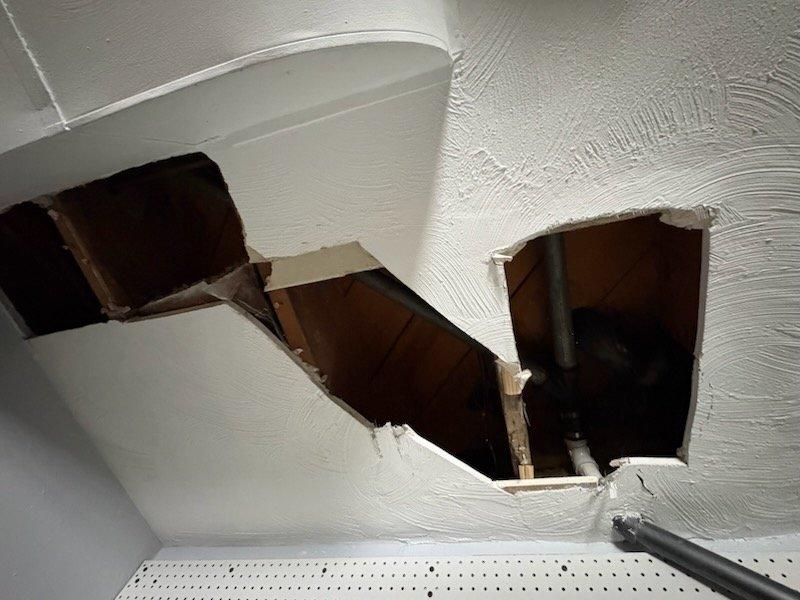 Completed return service for previously sold tub waste and overflow repair. Successfully removed aging cast iron drain piping and replaced with new PVC components, connecting to the existing PVC drainage system. Work required access through ceiling to reach and properly transition the old cast iron waste line to modern materials.