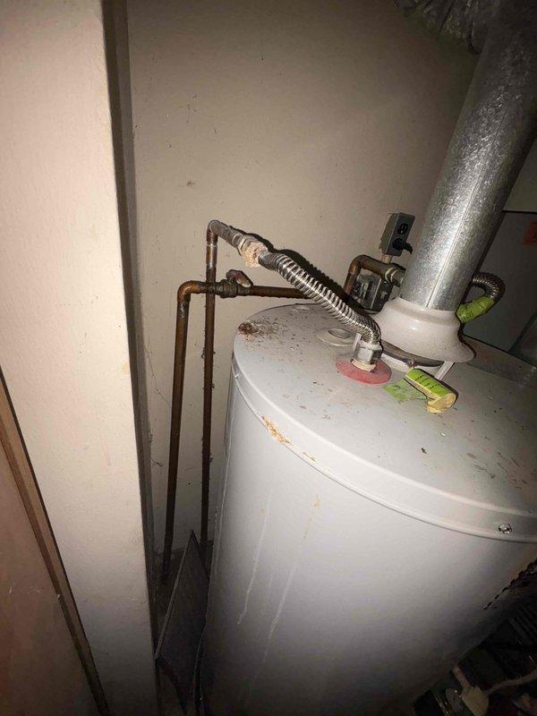 Responded to emergency call for leaking water heater. Upon inspection, identified an aging A.O. Smith gas water heater with visible corrosion and rust spots on tank surface. Determined the unit had reached end of service life with tank integrity compromised. Recommended immediate replacement to prevent potential water damage.