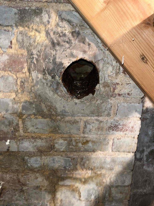 Performed club visit maintenance on dual system property (boiler and furnace air handler). Inspected ventilation piping and identified deterioration in brick wall surrounding exhaust vent penetration. Documented water damage and staining on masonry structure that may require future attention.