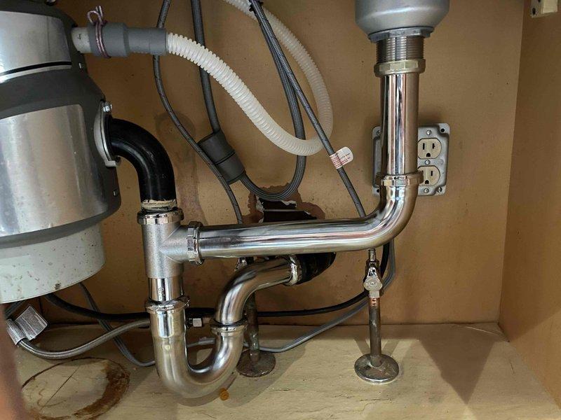 Diagnosed and repaired leaking kitchen sink faucet. Inspection of the plumbing system revealed minor water staining on the cabinet floor, indicating previous leakage. Completed necessary repairs to eliminate the leak and ensure proper function of the faucet assembly.