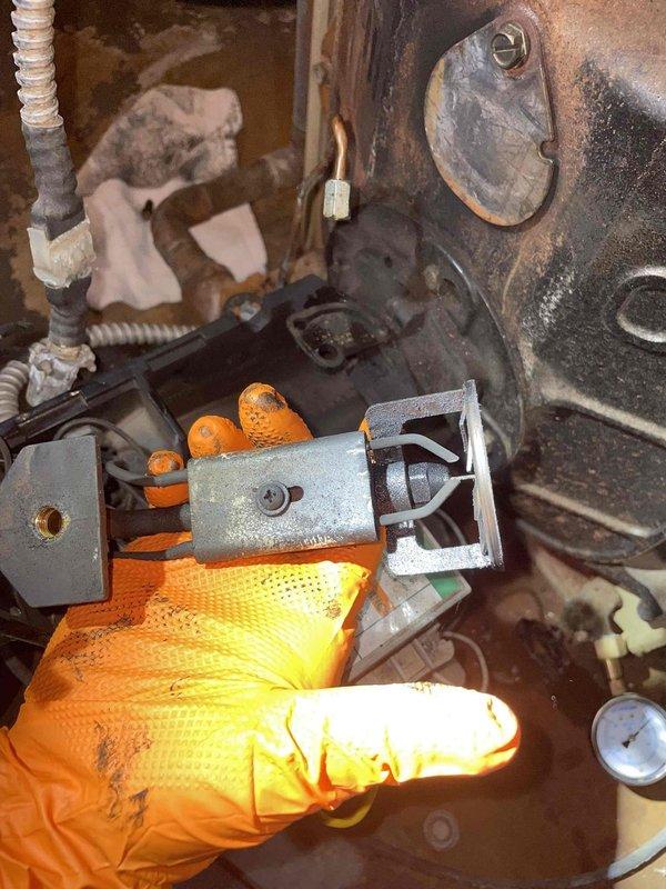 Responded to service call for 30-40 year old oil boiler that was repeatedly tripping reset button and exhibiting water feed line leak. Inspection revealed significant moisture buildup in pressure gauge and corrosion on internal components. Replaced damaged mounting bracket and addressed leaking water feed line to restore proper system operation.