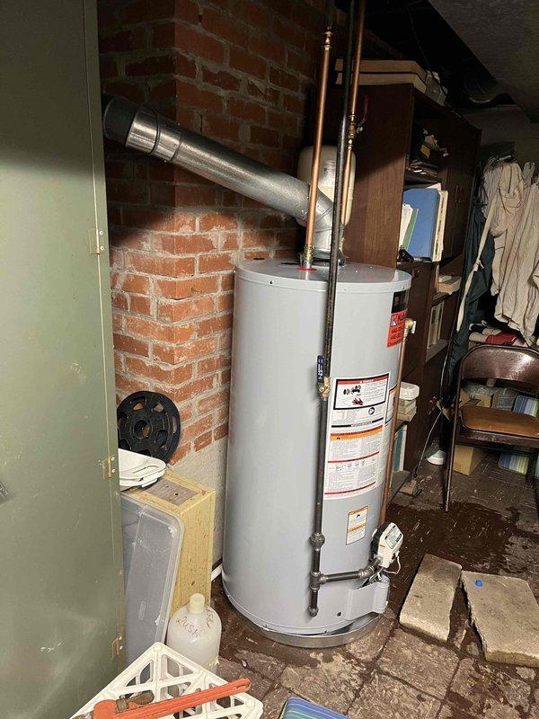 Responded to service call for 30-year-old water heater with pilot light failure. Upon inspection of the aging unit with copper supply lines and metal ventilation duct, determined the thermocouple had failed, preventing pilot light ignition. Replaced thermocouple, tested system operation, and confirmed proper hot water production.