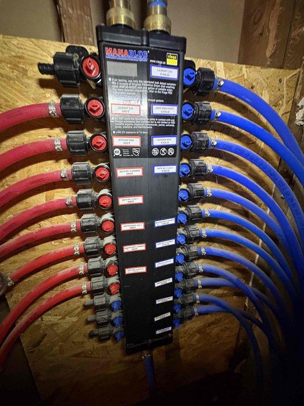 Responded to service call for leaking SharkBite fitting on custom shower head that was originally installed in 2022. Inspected the MANABLOC plumbing manifold system and verified proper alignment of the brass LEGEND shut-off valves using a WORKPRO level. Successfully repaired the leaking connection, restoring proper function to the shower fixture.