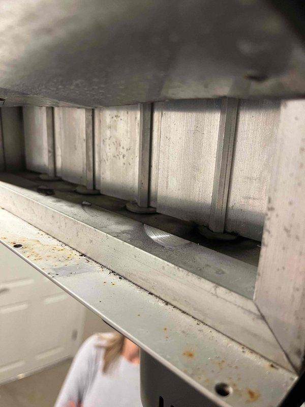 Completed zone damper replacement service by installing new 8x20 electric damper that was previously sold and available from inventory. Inspected existing HVAC system components, removed worn damper assembly showing signs of dust accumulation and metal deterioration, and verified proper operation of newly installed damper with the system control board.