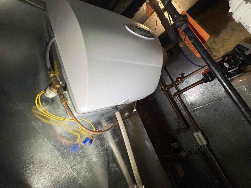 Responded to automatic water shutoff activation due to leak detection. Located leak source in HVAC room and inspected plumbing components including P-trap drainage system, supply lines, and water heater connections. Repaired leak, reset automatic shutoff system, and restored water service to the property.