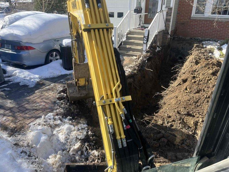 Completed relocation of sewer line by excavating trench in winter conditions and installing approximately 20 feet of new PVC piping to connect to existing sewer system. Successfully rerouted drainage configuration in basement utility area with proper elbow joints and vertical pipe arrangement, ensuring functional waste water discharge from the property.