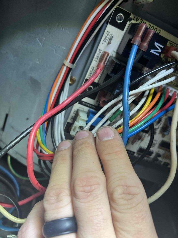 Diagnosed and repaired inoperative furnace fan issue by identifying faulty connections between the control board and fan relay. Reconnected blue and red wires to the COOL-HEAT terminal block, restoring proper electrical continuity to the system and successfully returning heating function to normal operation.