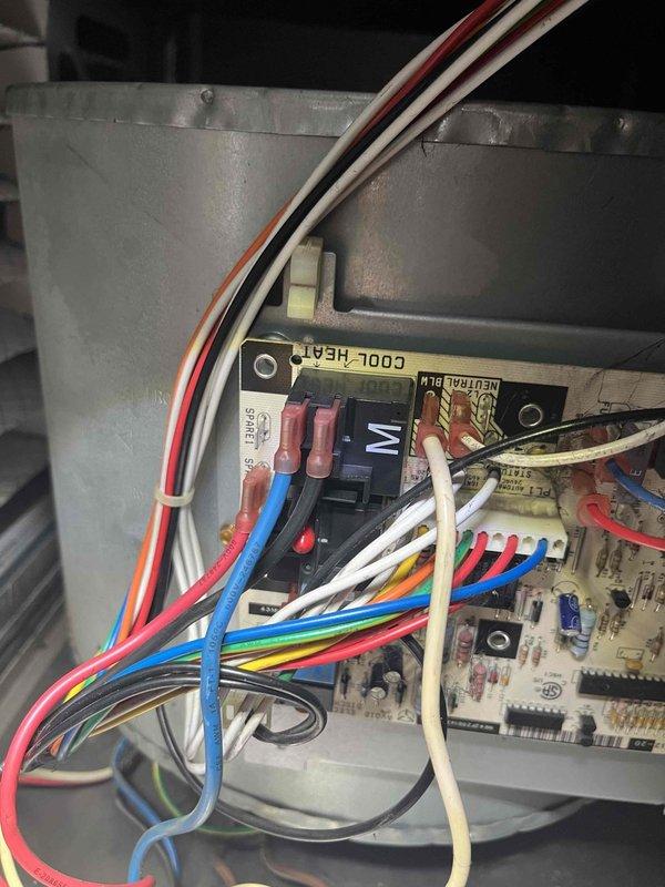 Diagnosed and repaired inoperative furnace fan issue by identifying faulty connections between the control board and fan relay. Reconnected blue and red wires to the COOL-HEAT terminal block, restoring proper electrical continuity to the system and successfully returning heating function to normal operation.
