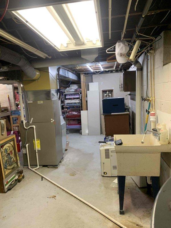 Performed 2-year heating maintenance service on air handler system in basement mechanical room. Conducted electrical testing with SC480 True RMS meter, verifying amperage readings of 48.6A. Discussed potential humidifier installation and minor ductwork modifications with homeowners for future consideration.
